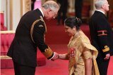 NRI Asha Khemka receives Damehood -- highest British honour -- at Buckingham Palace from Prince Charles