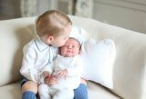 HRH Prince George tenderly kissing Princess Charlotte in first official photos of the new baby