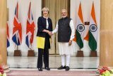 Theresa May and Narendra Modi shake hands to strengthen ties during May's first bilateral visit to india