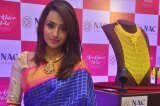 Trisha Krishnan poses next to the 1-Kilo gold necklace aimed as bridal jewellery