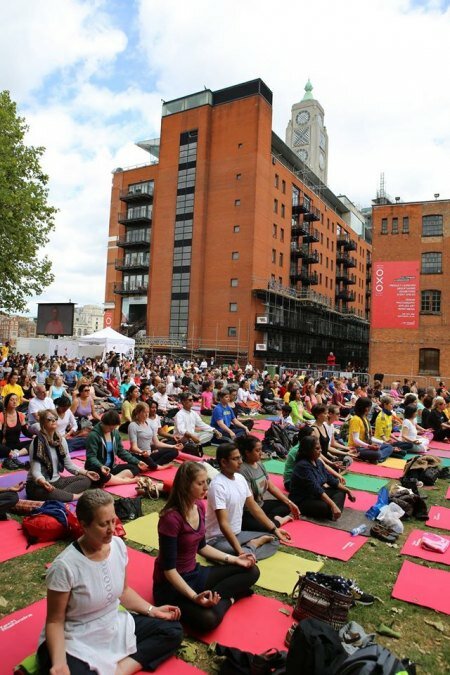 Yoga enthusiasts perform Yoga moves in unison in London