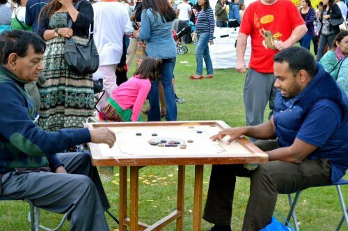 Visitors to London Mela 2013 at Gunnersbury Park in Ealing treated themselves to a game of Carrom - popular among Indians