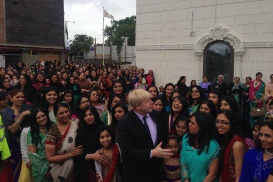 London Mayor shares a light moment with Indian women at the opening of Temple's £20m building, Purushottam Mahal
