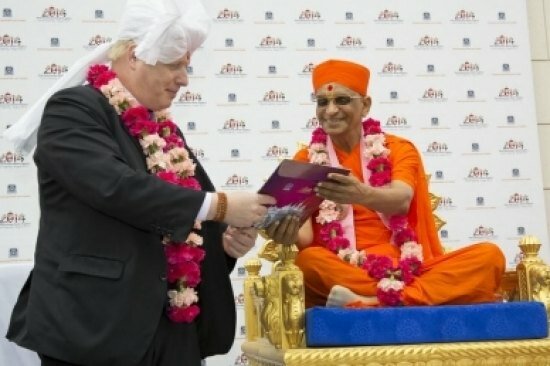 London Mayor Boris Johnson at Swaminarayan temple, Kingsbury being given red tikka, turban and garland by Hindu Maharaj
