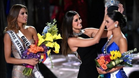 Miss Philippines (in blue gown) being crowned Miss Universe 2015 as Miss Columbia (left) looks on sportingly even as she holds the bouquet of flowers and the Miss Universe tag
