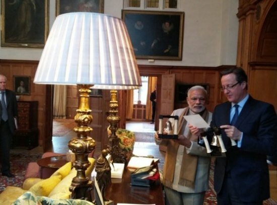Modi presenting Cameron with a pair of 'book ends' made of wood, marble and silver as a gift for the host