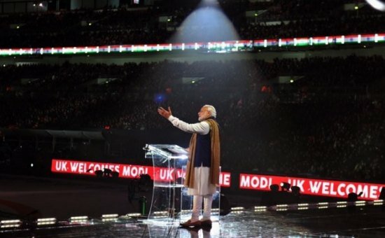 The spotlight at Wembley stadium shines on Indian PM Modi as he takes the stage to address the massive crowd gathered to see him and hear him
